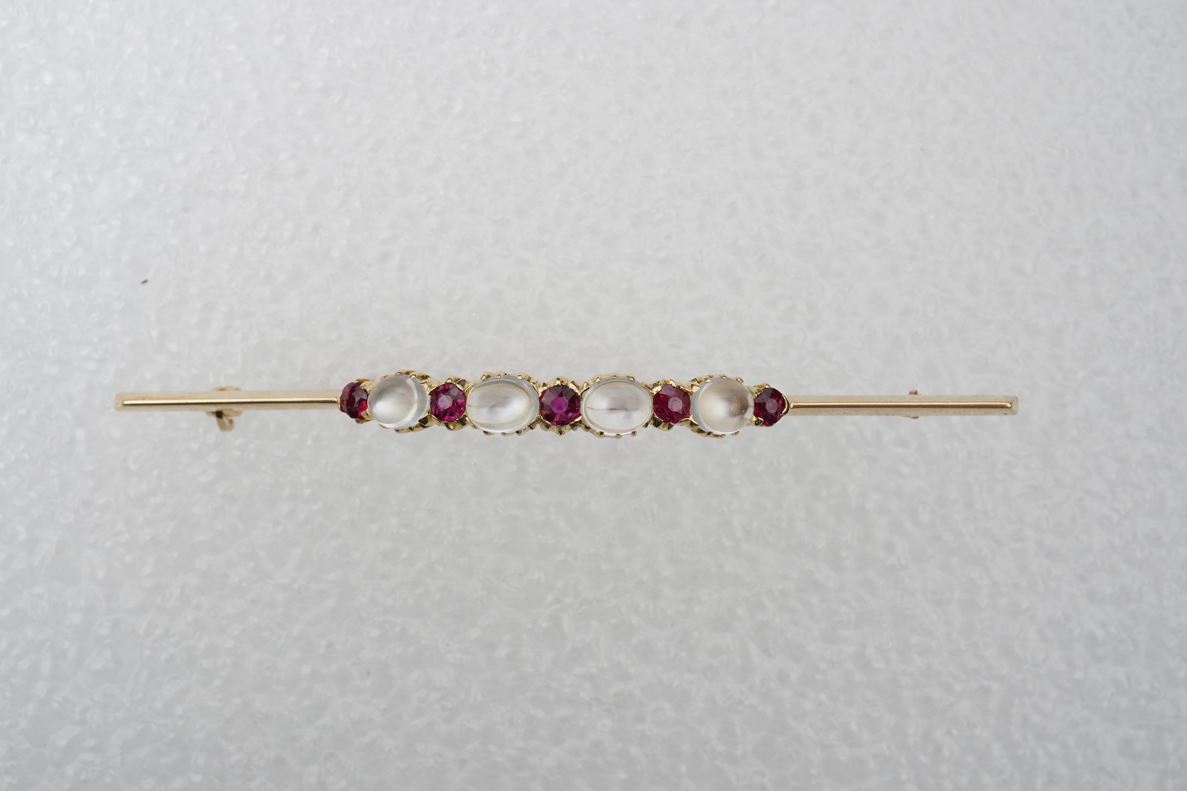 A moonstone and ruby brooch, circa 1900